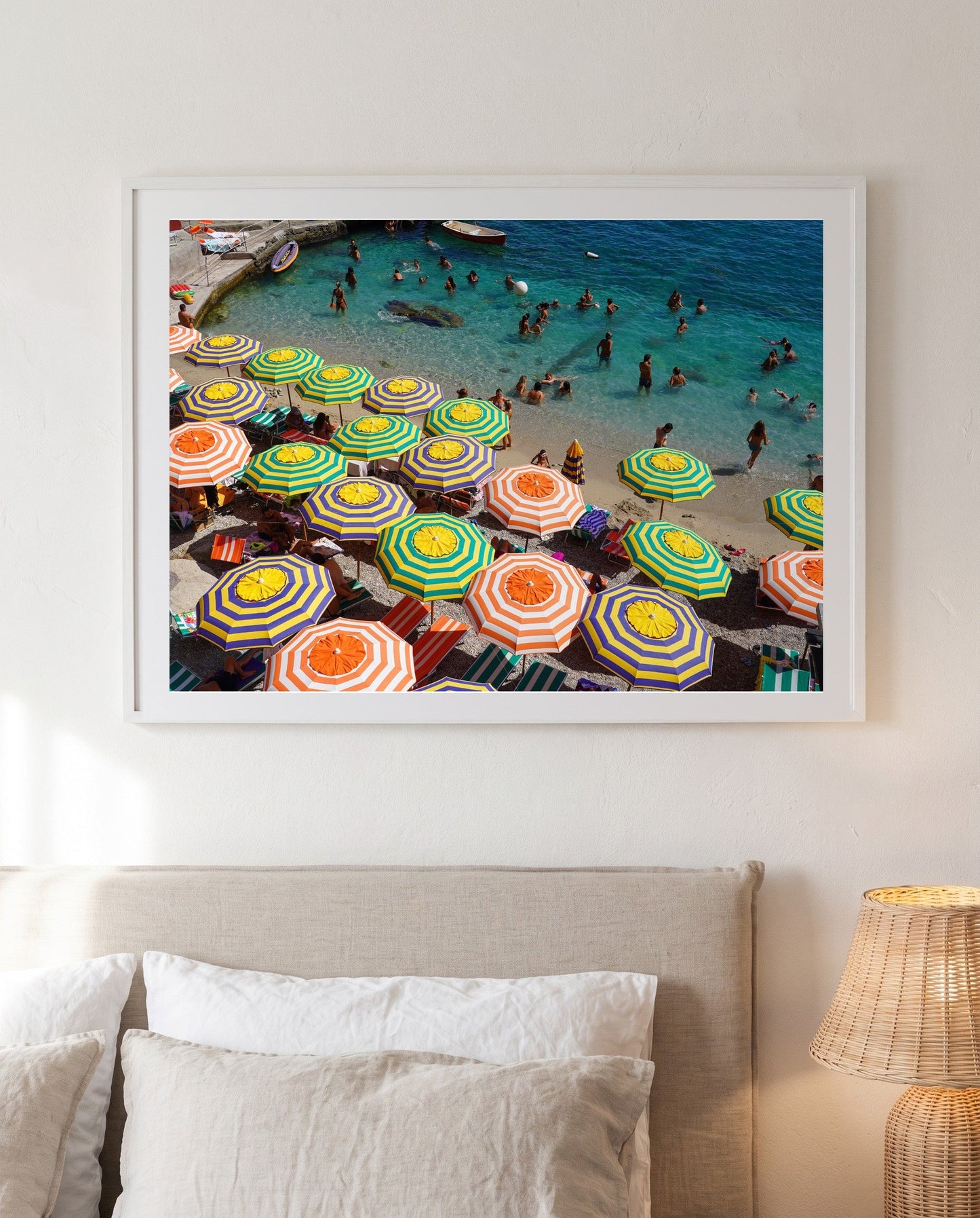 Shades of Capri framed above a linen bed
