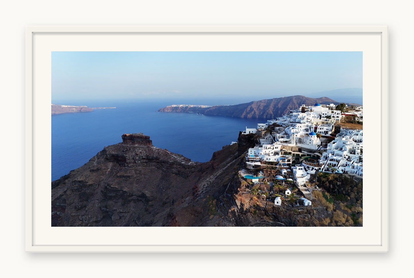 
                  
                    Skaros and Imerovigli, Santorini, framed in white with a 5 cm white border, shown at 66 x 87 cm
                  
                