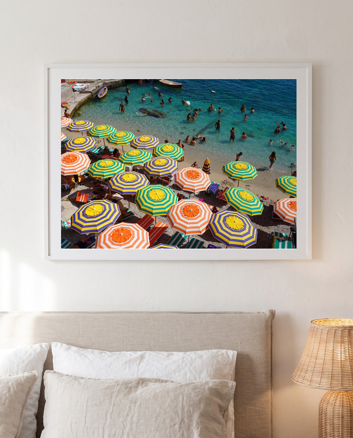 Shades of Capri, framed above a linen bed (styled interior)