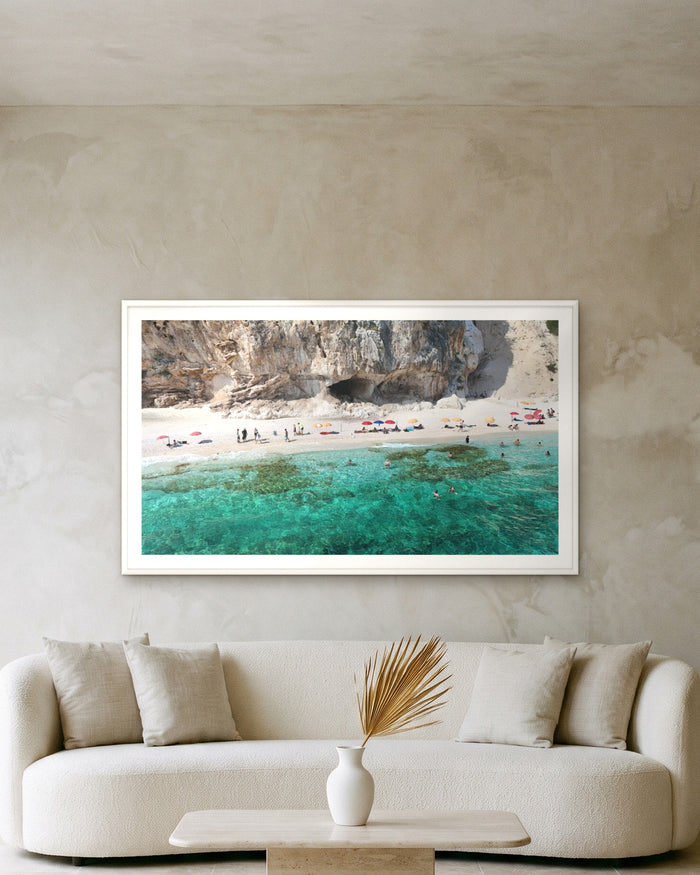 Beneath the Cliffs, Sardinia, framed on a textured plaster wall