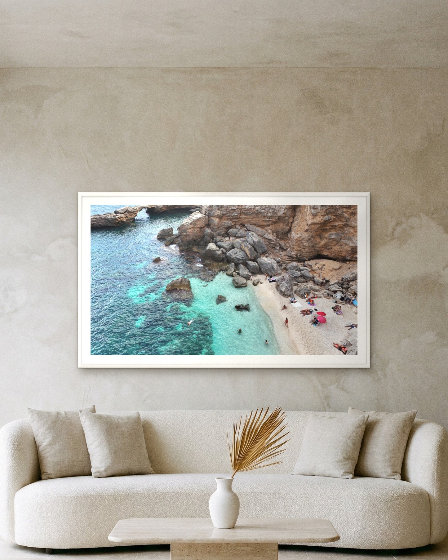 
                  
                    Turquoise Arch, Sardinia, framed with a 5 cm white border above a cream boucle sofa on a textured plaster wall
                  
                