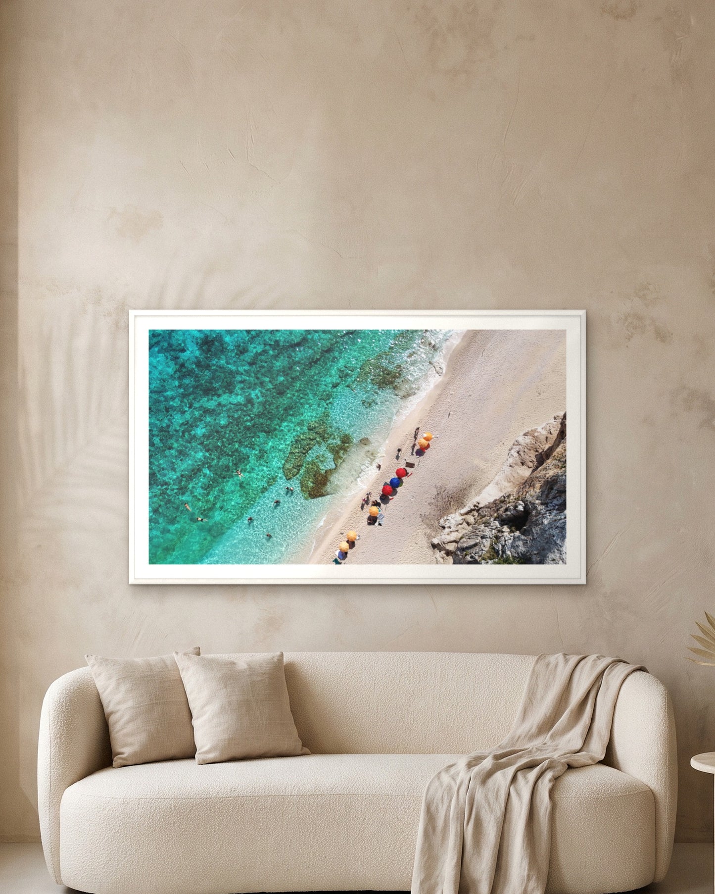 
                  
                    Umbrella Line, Sardinia, framed with a 5 cm white border above a cream boucle sofa on a textured plaster wall
                  
                