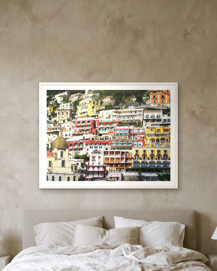 Vibrant Rainbow Riviera, Positano, framed on a textured plaster wall
