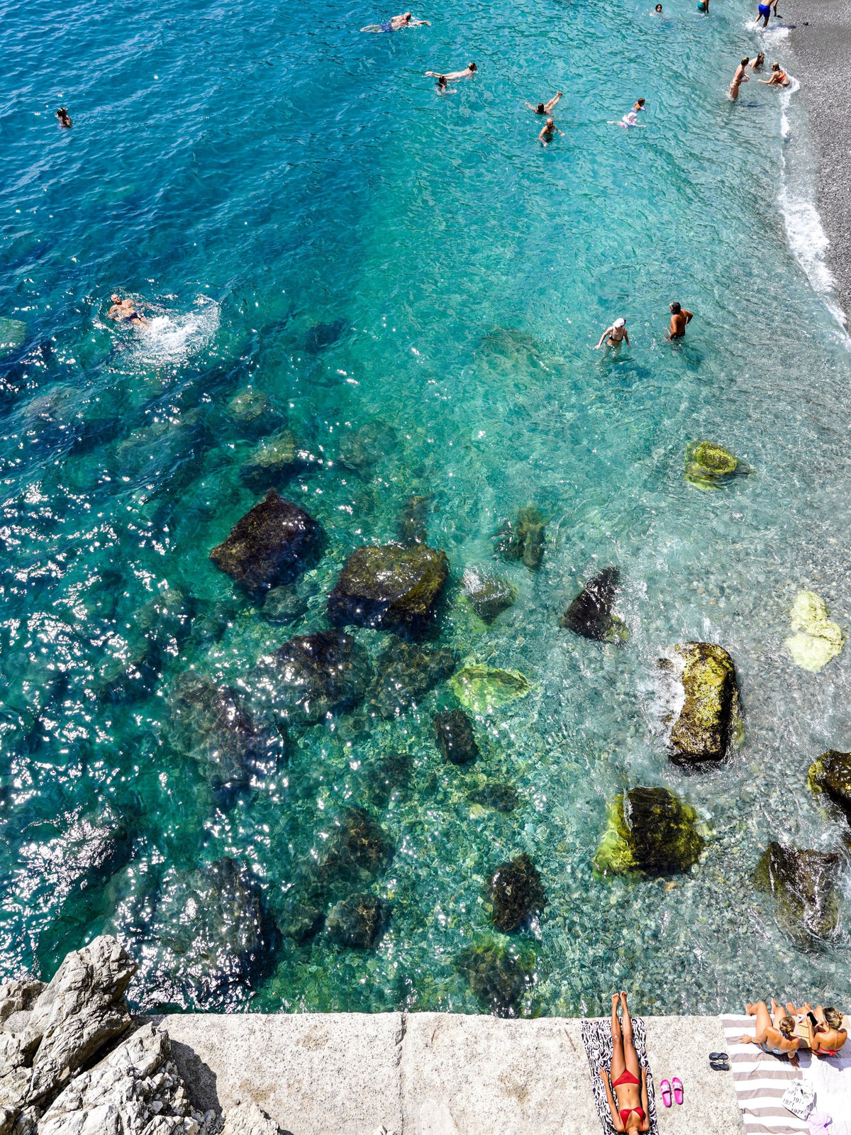 Swimmers in clear water on the Amalfi Coast
