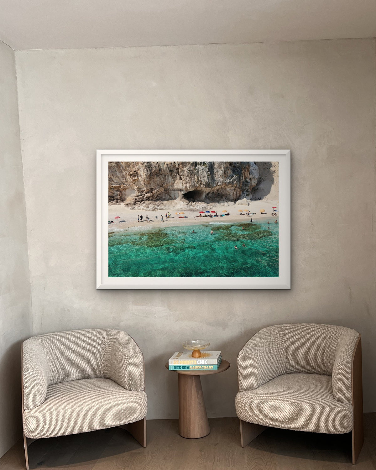 Mock-up: a framed Contemplo Sardinia print hung above two armchairs