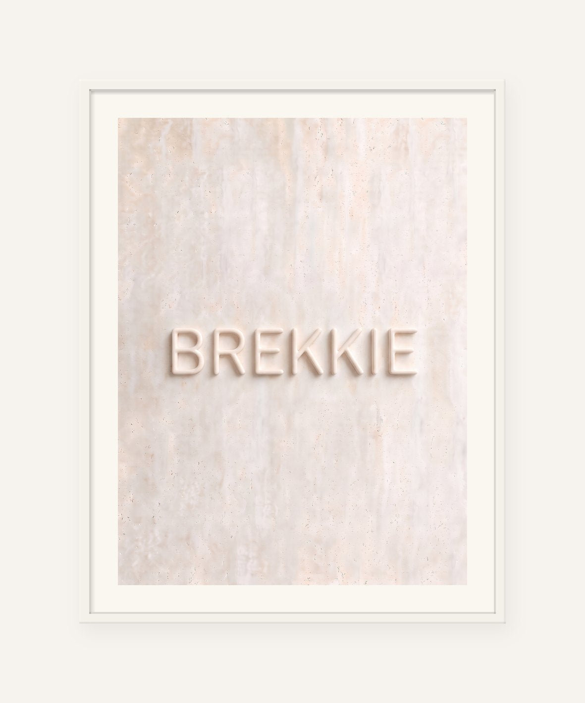 
                  
                    Brekkie, the word carved into soft marble, framed in white with a 5 cm white border
                  
                
