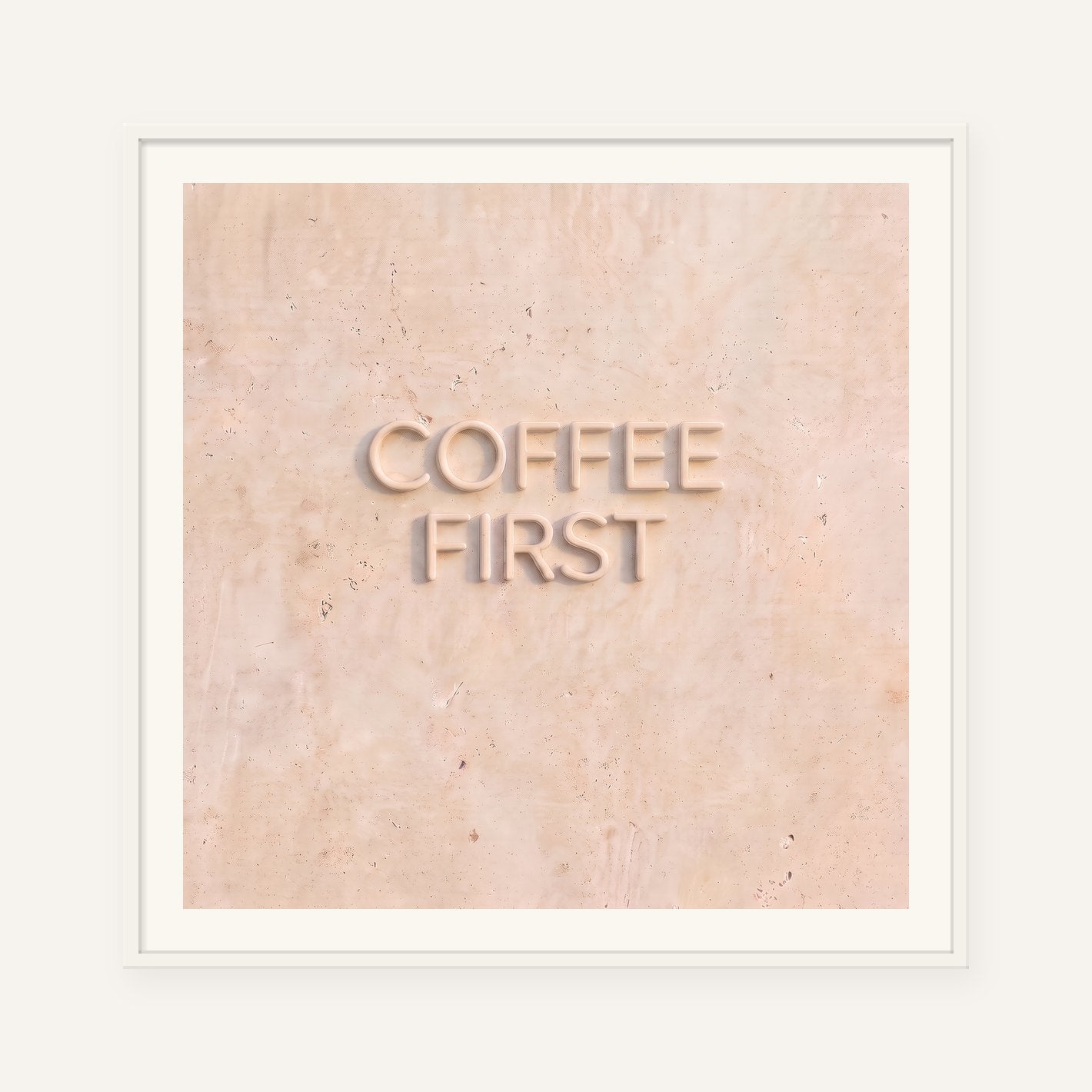
                  
                    Coffee First, the word carved into soft marble, framed in white with a 5 cm white border
                  
                