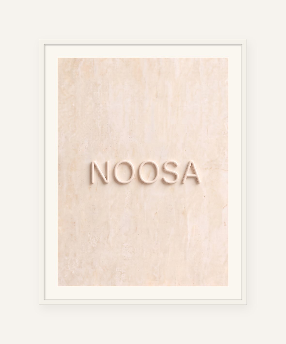 
                  
                    Noosa, the word carved into soft marble, framed in white with a 5 cm white border
                  
                